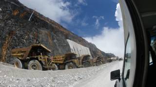 Line of overburden trucks waiting disposal  Grasberg Mine [upl. by Asilenna236]